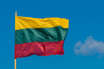 The flag of Lithuania flying in breeze wind on sky background