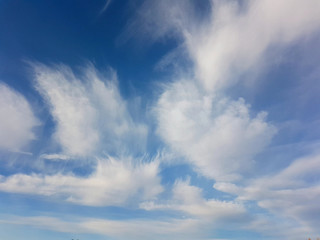 White clouds against a clear blue sky.