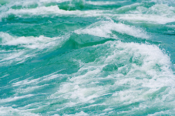 Blue ocean waves, tide. Swift current of river