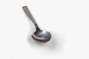 close-up. empty steel spoon on a white background. insulation.