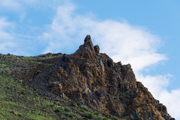 Rocks under blue sky. Sunny day in mountain valley. Colorful hills, Hiking in summer