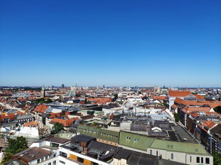 Fototapeta na wymiar View over the city of Munich from the tower of Saint Peter. Scenic summer aerial panorama of the Old Town architecture of Munich, Germany