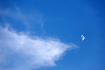 Naklejka na ściany i meble Crescent a day in blue sky, white clouds.