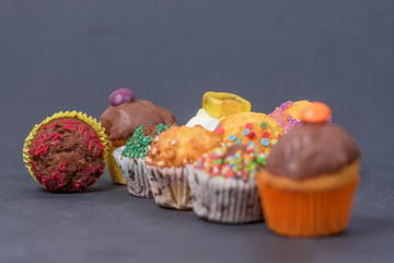 assorted fresh tasty muffins on dark background