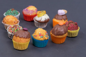 assorted fresh tasty muffins on dark background