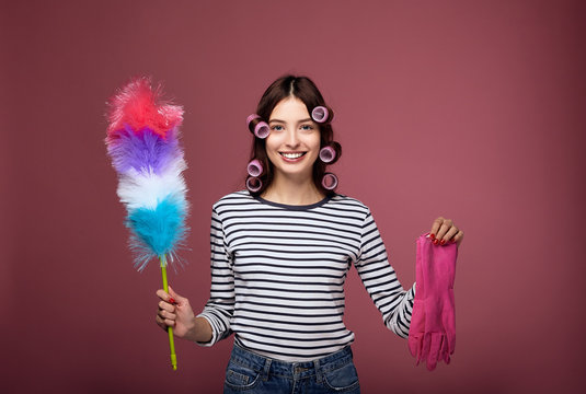 Young housewife in curlers is cleaned.