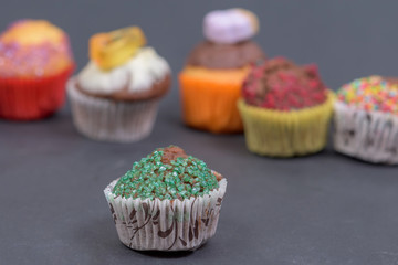 assorted fresh tasty muffins on dark background