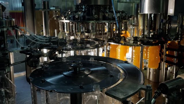 Manuufactoring of drinks on factory. Production shop of chemical industry plant with conveyor line for bottling beverages, juice and lemonade, soft drinks and making vitamins. Food industry concept.