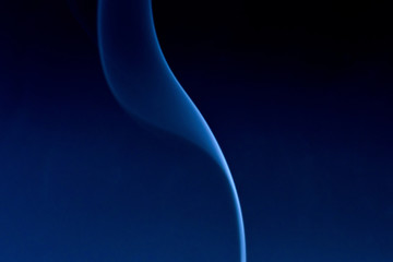 Cigarette smoke trail slowly evaporating background