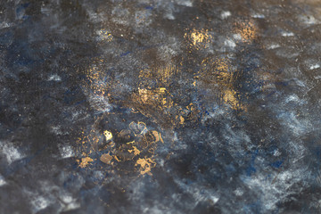 Deep blue with gold splashes over concrete.