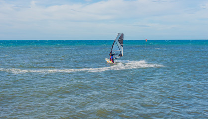 Funny windsurfing on the crystal clear water