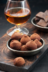 Chocolate truffles on wooden board. Atmospheric food photo
