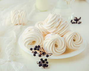 Handmade air russian fruitwhite marshmallow on a white background with beautiful dry berries. Homemade Sweets.