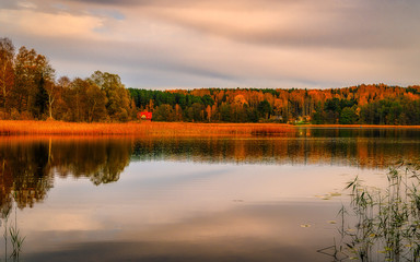 Fototapeta na wymiar autumn landscape with lake and blue sky