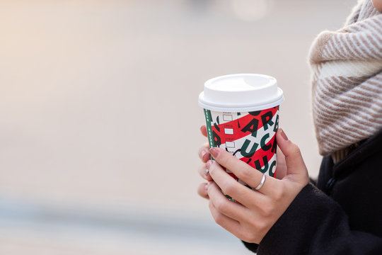 Woman hands holding hot Starbucks coffee paper cup, for Christmas and 2020 Happy New Year collection. Osaka, Japan- November 28, 2019