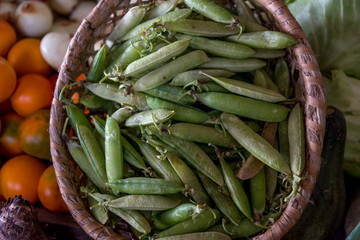 Peas in a basket for sale in an agricultural market in Colombia.