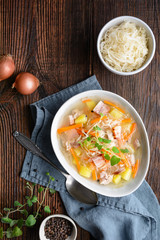 Kapusniak, classic Polish soup made from sauerkraut, pork ribs, smoked bacon, potato, carrot and other vegetable
