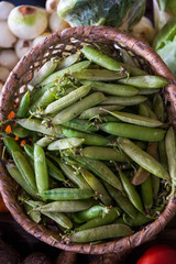 Peas in a basket for sale in an agricultural market in Colombia.