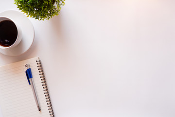 Top view white office desk table with the office equipments, computer keyboard and other office supplies on the modern space, flat lay.