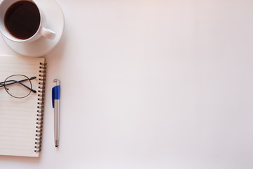 Top view white office desk table with the office equipments, computer keyboard and other office supplies on the modern space, flat lay.