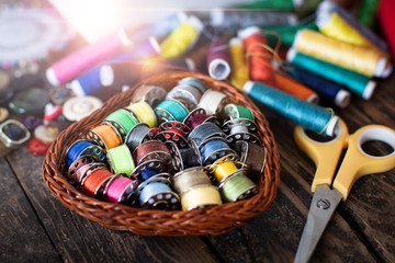 Many colorful threads and a sewing machine on the table