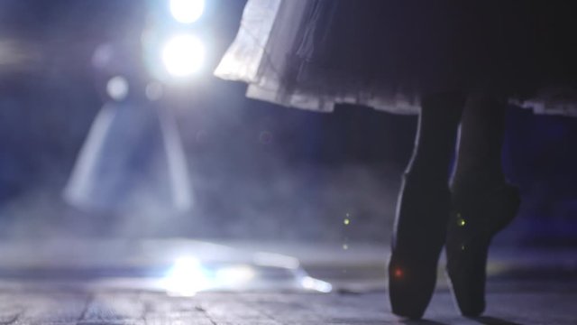 Classic ballet ballerina dancing on stage on Pointe