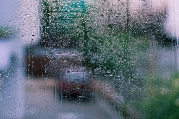 Wet window glass with street view