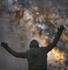 Fototapeta na wymiar Man enjoying starry night with arms wide open.