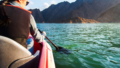 Woman kayaking in a lake closeup