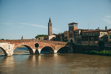 Obraz premium Beautiful view of traditional architecture and a bridge over a river in Verona in Italy.