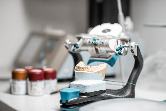 Dental articulator with jaw model on the table at the laboratory