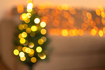 Blurred Christmas trees with a Christmas garland. Christmas concept.