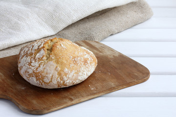 freshly baked ciabatta on a cutting board on the table. flavored pastries with golden brown