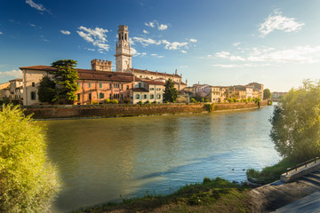 Verona cityscape during late sunset with Adige river and Church Complesso della Cattedrale-Duomo, viewed from the opposite side of river. Verona is located in Veneto, Italy,