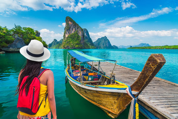 Traveler woman looking beautiful destinations place, Boat for tourist on Phang-Nga bay view Panyee...