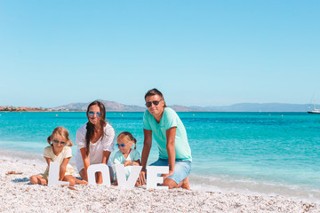 Happy beautiful family with kids on the beach