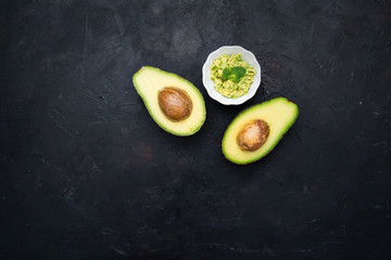 Avocados cut in halves with guacamole. Healthy food.