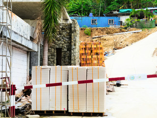 Storage of building materials on the street, bricks and blocks stacked on pallets