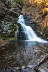Fototapeta na wymiar Beautiful waterfall cascading down rocks at Bushkill Falls. The 