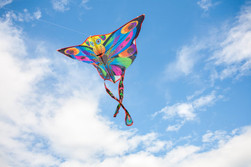 kite in hand against the blue sky in summer, flying kite launching, fun summer vacation