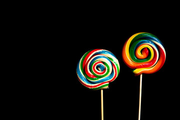 Colored lollipop on black background