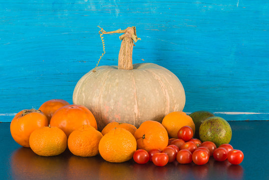 Fresh vegetables and fruits on the blue paint wooden background. Healthy eating or vegan concept. Selective focus, directly above