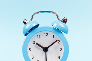 blue alarm clock on a blue background, copy spaсe	