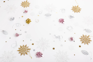 Christmas holiday composition. Festive creative gold silver pattern with ribbon on white background.