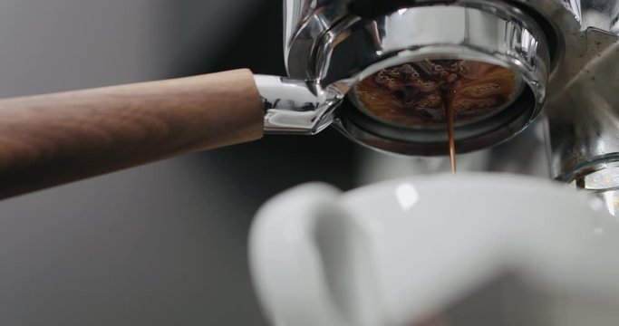 low angle shot of espresso extraction with bottomless portafilter