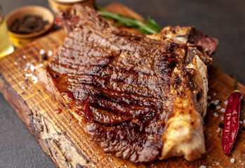 Grilled beef steak with spices. on stone background 