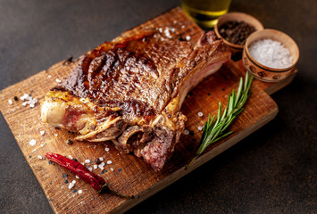 Grilled beef steak with spices. on stone background 