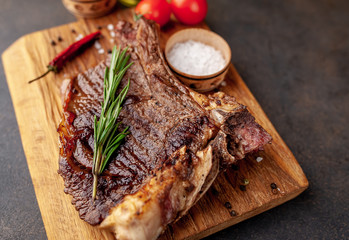 Grilled beef steak with spices. on stone background 