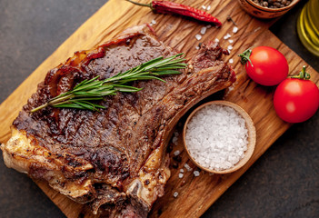 Grilled beef steak with spices. on stone background 