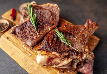 Grilled beef steaks with spices. on stone background